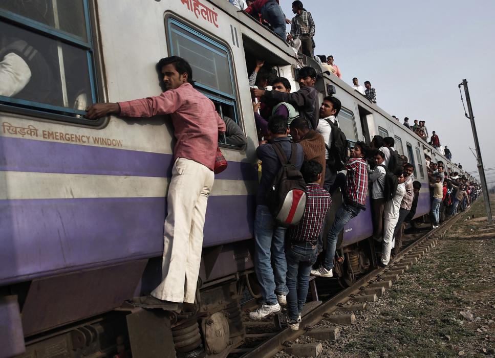 Passengers travel on an overcrowded train on the outskirts of New Delhi